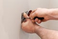 The hands of an electrician installing a wall power socket Royalty Free Stock Photo