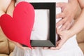 Hands embracing a pregnant woman belly with her hands holding a Royalty Free Stock Photo