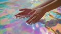 Hands Emerging From A Pool Of Iridescent Paints Royalty Free Stock Photo