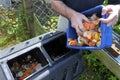 Hands emptying a container full of domestic food waste