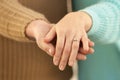 Hands of engaged young couple, closeup Royalty Free Stock Photo