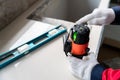 hands of engineer or construction worker using laser level instrument to measure the level inside the building. Construction and