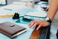 Hands engineer on table workplace in room at site construction. Book, blue print, calculater and tool of drawing blue print Royalty Free Stock Photo