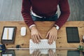 Hands on entrepreneurial experience. High angle shot of a man using a computer at his desk in a modern office. Royalty Free Stock Photo