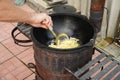 hands establish fried potatoes in a cauldron steam goes and boils oil Royalty Free Stock Photo