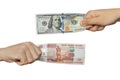 Hands exchange rubles for dollars.