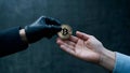Hands Exchanging Bitcoin: Symbol of Digital Currency Transfer Royalty Free Stock Photo