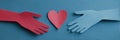 Hands Exchanging a Symbolic Heart in Paper Cut Style Representing Kindness and Connection in a Creative Artistic Royalty Free Stock Photo