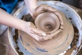 Hands of Experienced Female Potter Working with Clay. Posing with Clay Lump on Potter`s Wheel in Workshop Royalty Free Stock Photo