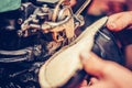 Hands of an experienced shoemaker stitching a part of the shoe