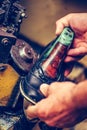 Hands of an experienced shoemaker working in a shoe factory