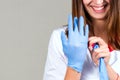 Hands and face of a woman doctor Close-up, puts on sterile glove Royalty Free Stock Photo