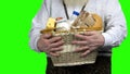 Hands of farmer holding basket of dairy products.