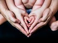 HANDS OF A FATHER A MOTHER I A CHILD IN THE FORM OF A HEART Royalty Free Stock Photo