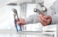 Hands with faucet and pipe wrench, install and construction home Royalty Free Stock Photo