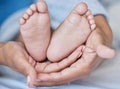 Hands, feet and baby with mother for love, care and security while together in family home. Woman or mom and child Royalty Free Stock Photo