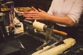 The hands of a female baker cook trdelnik or Trdlo national treat in the Czech Republic in winter