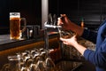 Hands of female bartender pouring from tap fresh beer into the glass Royalty Free Stock Photo