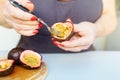 hands female chef with red manicure holding passion fruit in hands Royalty Free Stock Photo