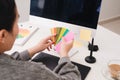 Hands of female designer in office working with colour samples. Woman at workplace choosing colourful paper charts. Creative Royalty Free Stock Photo