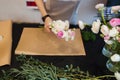 Hands of female florist creating bouquet on black table Royalty Free Stock Photo