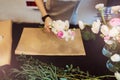 Hands of female florist creating bouquet on black table Royalty Free Stock Photo