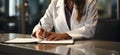 Hands of a female medical professional jotting patient symptoms, emphasizing diligent care