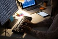 Hands of female programmer sitting at desk and using computer with coding on screen Royalty Free Stock Photo