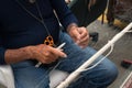 Hands of fisherman repairing the net