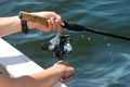 Hands on fishing reel Royalty Free Stock Photo