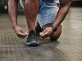 Hands, fitness and tie shoes in gym to start workout, training or exercise for wellness. Sports, athlete health and Royalty Free Stock Photo