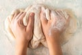 hands in flour crumple the dough for pizza or pies, the process of cooking bakery products Royalty Free Stock Photo