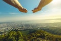 Hands of flying man against the background of the picturesque landscape of the city and the sea on a sunny day. Concept of movemen Royalty Free Stock Photo