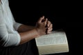 Hands folded in prayer on a Holy Bible in church concept for faith Royalty Free Stock Photo