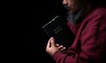 Hands folded in prayer on a Holy Bible in church concept for faith, spirituality and religion, man praying in morning. Man hand