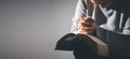 Hands folded in prayer on holy bible in church concept for faith, spirituality and religion. Unrecognizable woman holding a bible Royalty Free Stock Photo