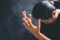 Hands folded in prayer on a Holy Bible in church concept for faith, spirituality and religion, woman praying on holy bible in the Royalty Free Stock Photo