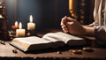 Hands folded in prayer on a Holy Bible in church concept for faith, spirituality and religion, woman praying on holy bible Royalty Free Stock Photo