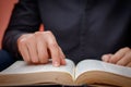 Hands folded in prayer on a Holy Bible in church concept for faith, spirtuality and religion Royalty Free Stock Photo