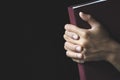 Hands folded in prayer on a Holy Bible  in church concept for faith, spirtuality and religion, Worship, sins and prayer Royalty Free Stock Photo