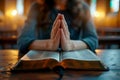 hands are folded in prayer on a Holy Bible .Holy Bible study reading together in Sunday . Generative AI Royalty Free Stock Photo