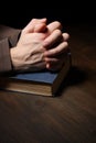 Hands folded in prayer over a Holy Bible Royalty Free Stock Photo
