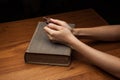 Hands folded in prayer over Holy Bible Royalty Free Stock Photo