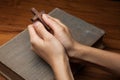 Hands folded in prayer over Holy Bible Royalty Free Stock Photo