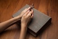 Hands folded in prayer over Holy Bible Royalty Free Stock Photo