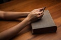 Hands folded in prayer over Holy Bible Royalty Free Stock Photo