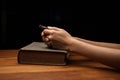 Hands folded in prayer over Holy Bible Royalty Free Stock Photo