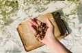 Hands folded in prayer over old Holy Bible. Wooden background.Hands and rosary, prayer, old book with yellow pages. white flowers Royalty Free Stock Photo