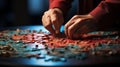 Hands folding puzzle at table and putting last piece closeup