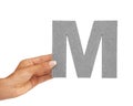 Hands, font and capital letter M in studio isolated on a white background mockup space. Fingers, alphabet or closeup of